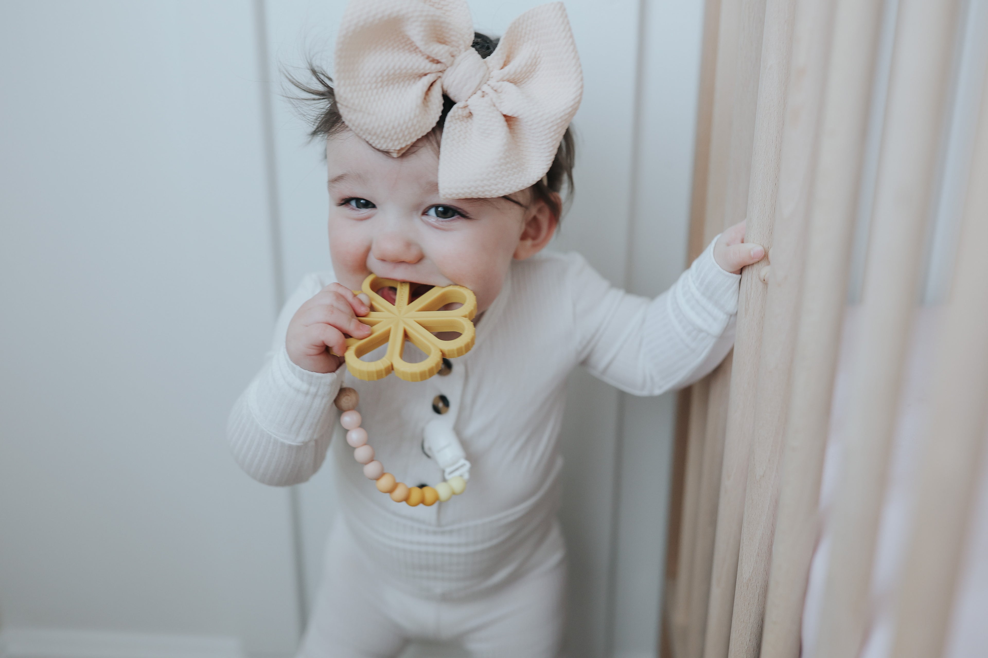baby girl with yellow flower teether